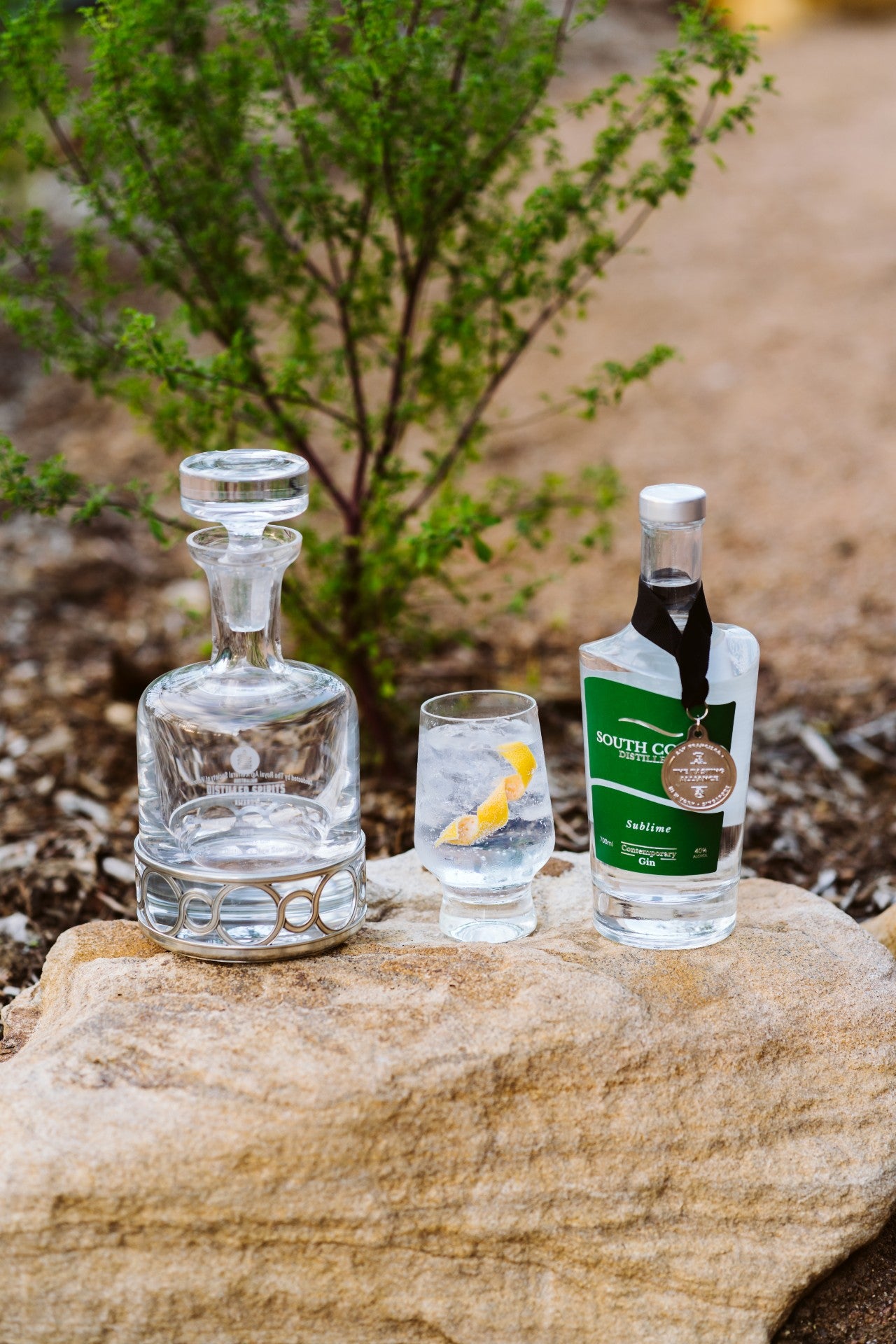 A showcase of Sublime contemporary gin, displaying awards from San Francisco Worlds Spirit Awards and London Gin Awards, and a Gin and Tonic