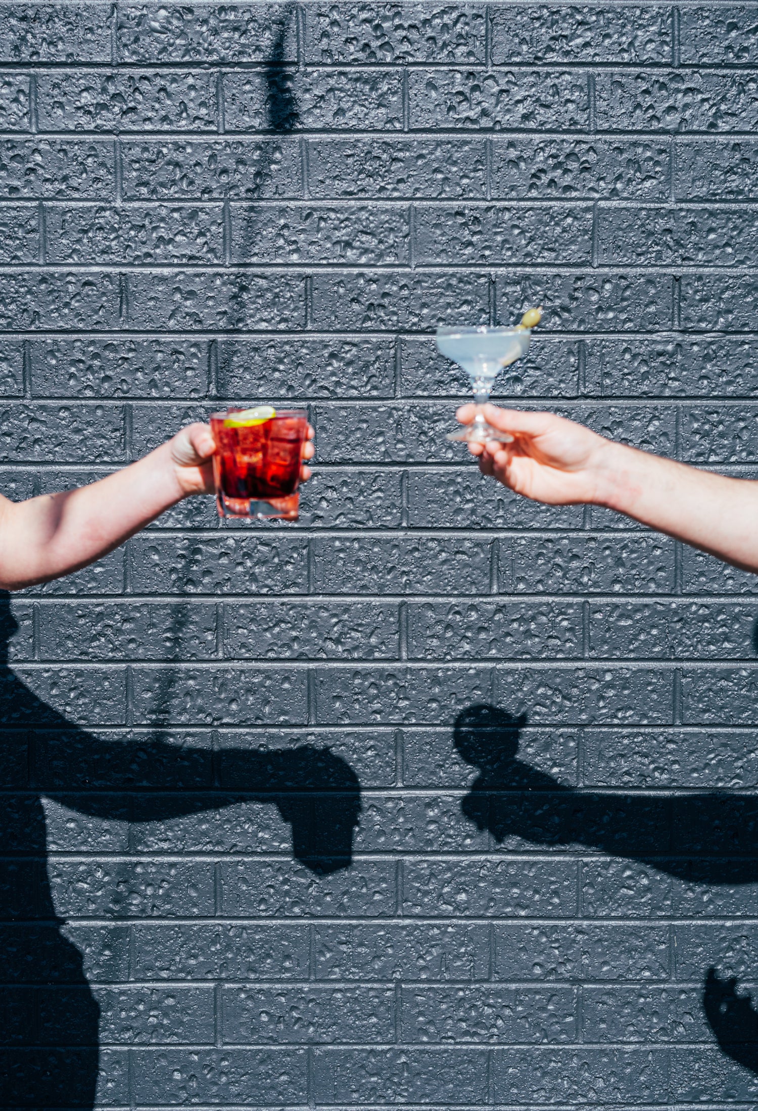 Two classic gin cocktails, a negroni and a martini, shared in front of the distillery